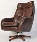 A vintage Scandinavian chocolate brown genuine leather swivel button back pod armchair with five