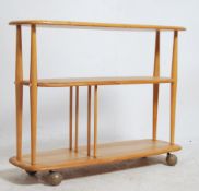 An Ercol beech and elm wood 20th century low room divider having chamfered edge lozenge shaped tiers