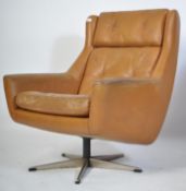 A retro 1960's mustard yellow leather swivel armchair of angular form being raised on a chrome 5