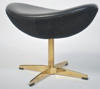 After Poul Volther. A stunning black leather and gilded polished steel Corona footstool / foot