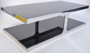 A superb 1970's chrome and black glass coffee table of angular form with chrome rectangular twin