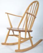 An Ercol 20th century blond wood retro rocking chair in the windsor pattern. Sleigh runners with