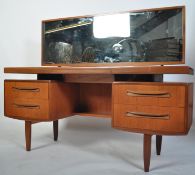 A 1970's G-Plan teak wood dressing table in the manner of Mogens Kolo. The dressing table raised