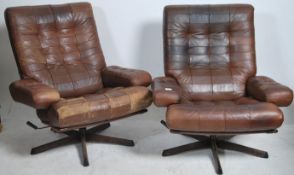 A pair of retro mid century Swedish leather patchwork upholstered swivel armchairs by Gote Mobler