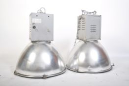 A pair of 20th century Industrial Hillclare factory pendant lights having half sphere polished