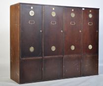 A large 20th century Industrial panel wood locker unit having multiple locker doors with vented