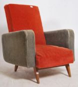 A 1970's French retro two tone armchair being raised on turned and tapering angled teak legs