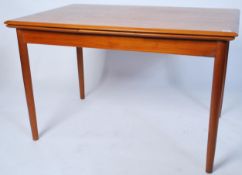 A good mid century Danish draw leaf teak wood refectory extending dining table having tapering
