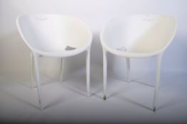 A pair of contemporary white plastic ' basket ' style chairs in the manner of Alessandro Busana.