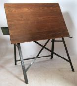 A mid century Industrial architects / draftsmans board having a panel wood board set over a cast