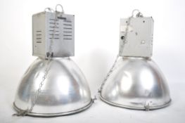 A pair of 20th century Industrial Hillclare factory pendant lights having half sphere polished
