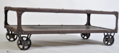 A vintage industrial style cart coffee table, having limed top and lower oak tiers with an iron