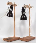 A pair of mid century Industrial Laboratory / lab stands raised on wooden bracket supports with drop