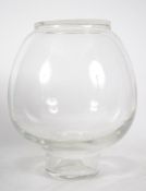 A vintage retro mid 20th century large and heavy glass coin collection jar having coin slot to