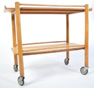 A stunning mid century blond wood tea - serving table raised on original castors with beautiful