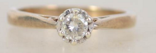 A ladies 9ct gold and diamond ring having a central claw mounted diamond approx 25pnts. Total weight