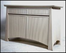 A retro 20th century Art Deco revival  designer painted sideboard having rattan weave facia cupboard