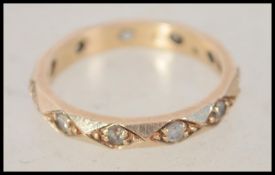 A 9ct gold and paste stone set eternity ring. The