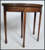 An Edwardian mahogany demi -lune card table being