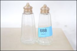 A pair of silver hallmarked and cut glass salt and