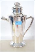 An unusual silver plated cocktail shaker in the fo
