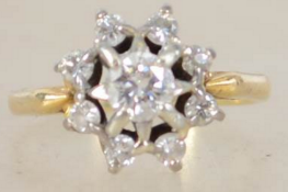 An 18ct gold and diamond ring having starburst mou