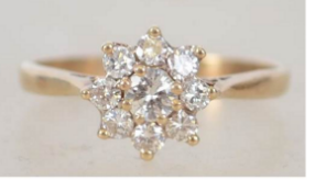A 9ct gold and diamond flower head cluster ring approx 50pnts in total. Weight 1.6g / Size L