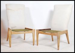 A pair of mid century Parker Knoll armchairs raise