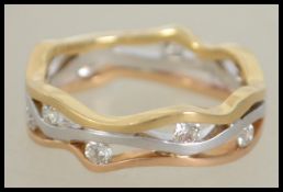 An 18ct  tri colour gold abstract band ring set wi