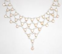 A sterling silver festoon necklace being adorned w