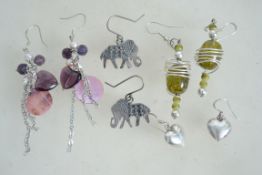 Four pairs of sterling silver earrings one being a