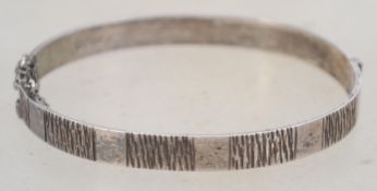 A sterling silver bangle bracelet of naturalistic