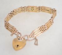A Victorian rolled gold gate bracelet being set wi