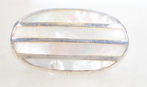 A large silver and mother of pearl statement ring.