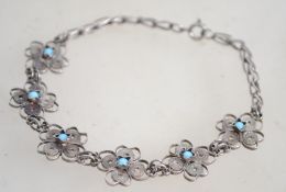 A sterling silver and turquoise bracelet having fi