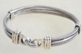 A sterling silver bangle bracelet having two rigid