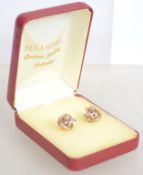 A pair of 9ct gold trilogy earrings of knot form w