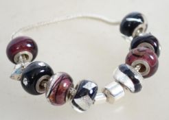 A sterling silver fox tail link charm bracelet hav