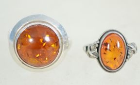 Two sterling silver and amber ladies dress rings.