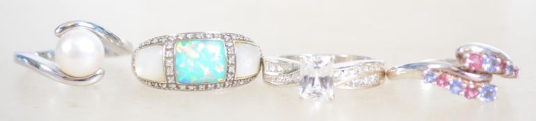 A group of 4 ladies dress rings one being set with