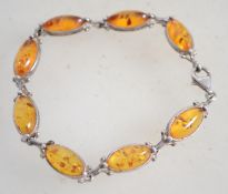 A sterling silver and amber bracelets having amber