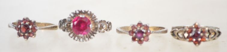 A group of 4 silver ladies dress rings each set wi