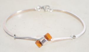 A sterling silver and amber bracelet of unusual fo