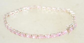 A sterling silver and CZ tennis bracelet having pi