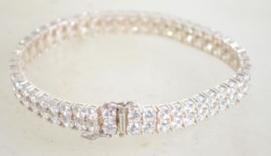 A sterling silver and CZ tennis bracelet having tw