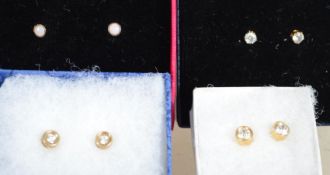 Four pairs of 9ct gold earrings three of which are