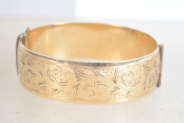 A heavy vintage 9ct rolled gold bangle being half