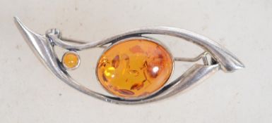 A sterling silver and amber brooch with a rollover