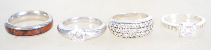 A group of 4 sterling silver dress rings, one bein