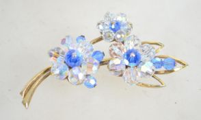 A vintage 1950s crystal flower brooch in a gold to
